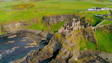 Aerial-clockwise-orbital-shot-of-Dunluce-Castle,-Northern-Ireland