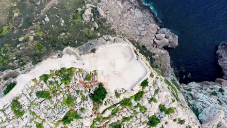 Aerial-View-of-Sunlit-Ocean-in-Empty-Outdoor-Landscape-with-Viewing-platform-on-mountain-top