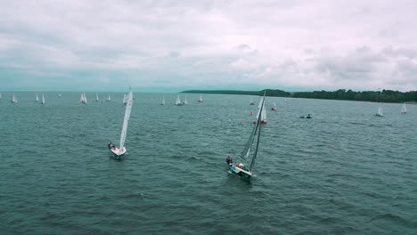Aerial-view-of-drone-flying-towards-the-yachts-racing-in-regatta-on-the-sea
