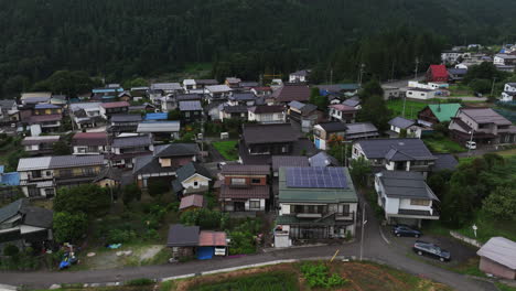 Drone-shot-overlooking-classic-neighborhood-homes-in-the-suburbs-of-cloudy-Japan