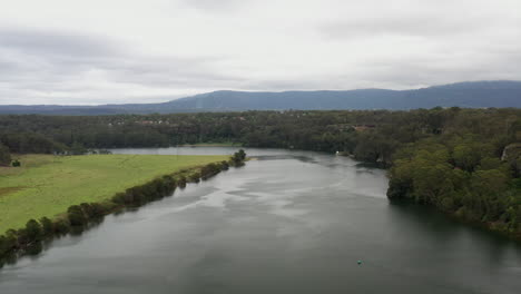 Aerial-drone-shot-flying-up-the-Shoalhaven-river-on-a-stormy-day-near-Nowra,-NSW-Australia