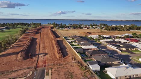 Aerial-descending-over-new-home-construction-site-with-Black-Bull-Golf-Course-and-Lake-Mulwala-beyond