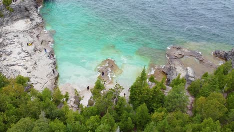 Rocky-beach-and-green-forest-of-Bruce-peninsula,-aerial-drone-view