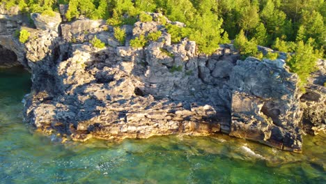 The-pine-trees-covered-rocky-banks-with-the-deep,-crystal-clear-waters-of-Lake-Huron