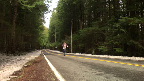 skateboarder-skating-though-a-forest-road