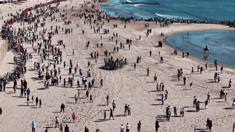 Lively-Feria-scene-at-crowded-Palavas-beach-with-horse-riders,aerial-view