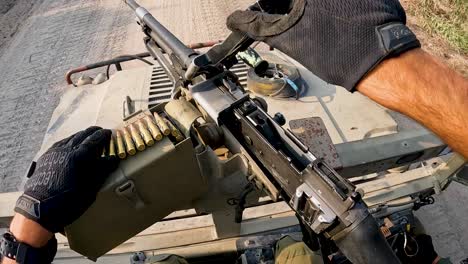 Military-loading-bullets-in-gun-machine-armed-vehicle-during-Israel-Hamas-War-2023