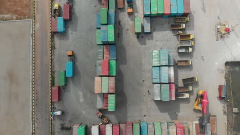 Top-down-view-of-cargo-port-with-sea-containers-at-Belitung-indonesia,-aerial