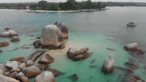 Giant-granite-boulders-in-sea-at-Belitung-island-indonesia,-aerial