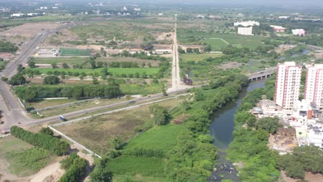 RAJKOT-CITY-AERIAL-VIEW-A-big-building-is-visible-a-big-river-is-flowing-and-the-drone-is-going-round-and-round
