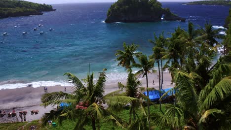 Seaside-Resort-On-The-Palm-Tree-lined-Beach-In-Crystal-Bay-Nusa-Penida,-Bali-Indonesia