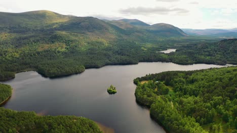 Aviemore-Aerial-Majesty:-The-Timeless-Loch-An-Eilein-and-Castle-Overlooked-by-a-Scots-Pine-Forest-Canopy,-Cairngorms,-Scottish-Highlands
