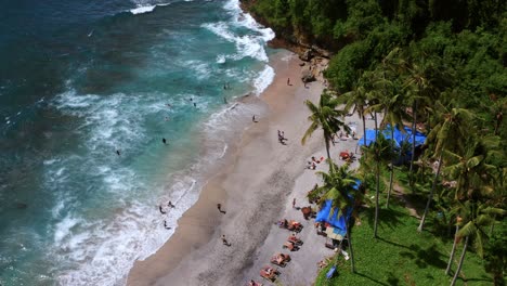 Tourists-At-Crystal-Bay-Beach-In-Nusa-Penida-Island,-Bali,-Indonesia---aerial-drone-shot