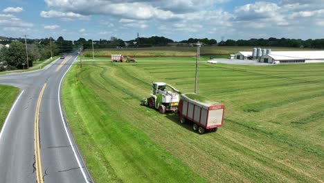 Forage-harvester-picking-up-chopped-hay-to-make-silage-at-American-farm