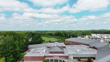 Aerial-ascending-footage-of-school-complex-with-sports-facilities