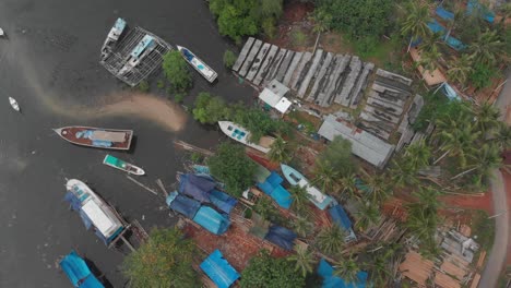 Top-down-view-of-local-boat-construction-site-at-Indonesia,-aerial