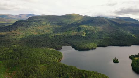 Loch-An-Eilein's-Aerial-Portrait:-Scots-Pine-Forest-Silhouettes,-Aviemore-in-the-Scottish-Highlands,-Scotland,-United-Kingdom