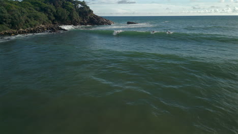 Aerial-Drone-Shot-of-Caucasian-Male-Surfer-Surfing-on-Wave-in-Hiriketiya-Bay-Sri-Lanka