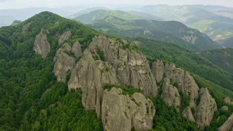 Drone-retreating-and-revealing-the-expanse-of-the-rock-phenomenon-Karadzhov-Kamak,-one-of-the-peaks-of-the-famous-energy-triad,-in-Northern-Rhodopes-in-Central-Bulgaria