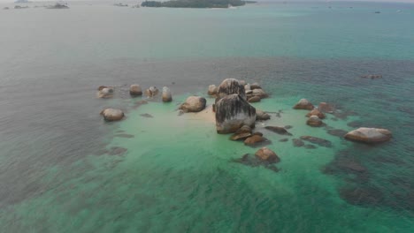 Big-granite-boulders-in-middle-of-sea-at-Belitung-island-Indonesia,-aerial