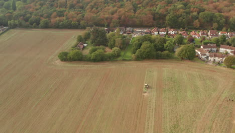 Stationary-aerial-shot-of-a-tractor-ploughing-a-large-field