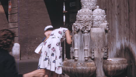 Woman-with-her-Son-Drinking-Water-from-the-Fontana-delle-Tiare-in-Rome-1960s