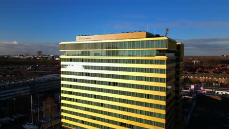 Tall-Holiday-Inn-modern-hotel-facade-drone-orbit-Amsterdam-Noord-aerial