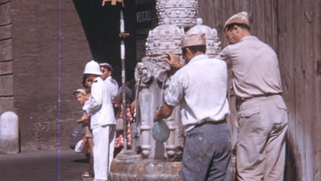 Männer-Füllen-Wasserflaschen-Auf-Dem-Weg-Zur-Arbeit-In-Fontana-Delle-Tiare-In-Rom