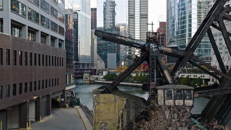Aerial-view-rising-behind-the-Chicago-and-Northwestern-Railway-Bridge,-fall-evening-in-Loop