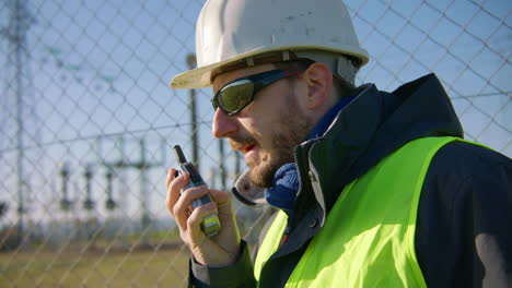 Close-up,-man-wearing-personal-protective-equipment-and-using-radio