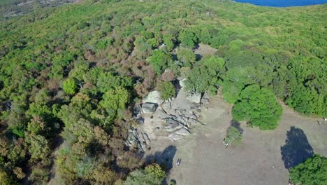 Descending-drone-shot-of-Beglik-Tash-and-the-coastline-of-the-Black-Sea-in-Primorsko,-Burgas-Province,-Bulgaria