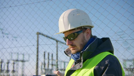 Engineer-on-location-communicating-with-colleagues-via-walkie-talkie
