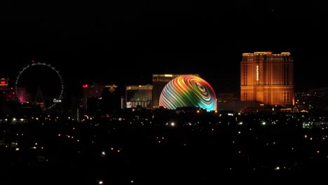 Nighttime-view-of-the-MSG-Sphere,-The-LINQ,-and-Palazzo-Hotel-in-Las-Vegas---aerial