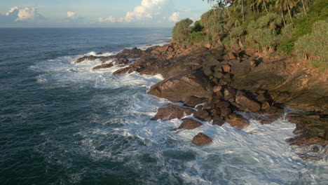 Aerial-Drone-Shot-Rotating-Around-Rocky-Shoreline-in-Tropical-Sri-Lanka-with-Waves-Crashing-60-FPS