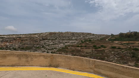 Rocky-landscape-of-Malta,-view-from-moving-car