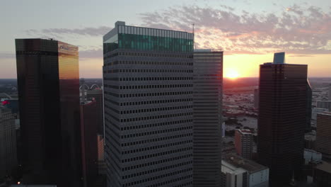 Aerial-view-away-from-the-Republic-Center,-colorful-sunset-in-Dallas,-USA