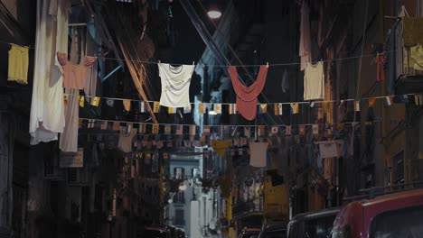 Hanging-clothes-in-a-vibrant-Naples-street-at-night,-Italy