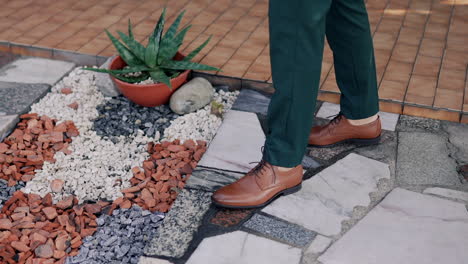 Stylish-man-formal-dressed-on-Textured-Garden-Walkway-detail