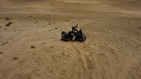 Motorcyclist-stuck-in-the-sand-of-a-steep-hill-or-dune-in-the-desert