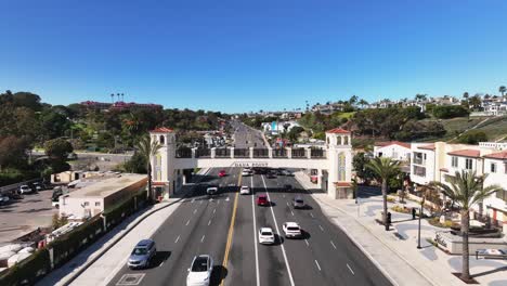 Cars-Driving-On-Pacific-Coast-Highway-Under-The-Footbridge-In-Dana-Point,-California,-USA