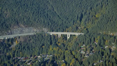 Eagle-Harbour-Bridge-on-Forested-Mountain-Slope-Aerial-View-from-Plane