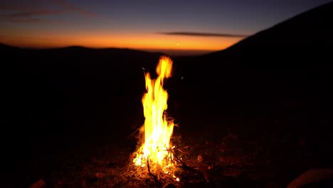 Soothing-calm-wildnerss-bonfire-burning-at-nature-sunset-campsite