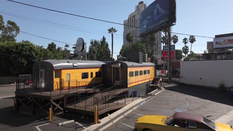Carney's-classic,-famous-rail-car-restaurant-in-Los-Angeles,-California,-aerial-rising