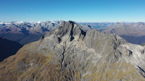 Aerial-flying-toward-a-rocky-peak-in-New-Zealand's-Southern-Alps-mountains