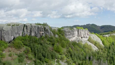 Drone-strafing-in-front-of-Belintash-Plateau,-a-picturesque-natural-rock-formation-situated-in-Rhodope-Mountains,-in-the-province-of-Plovdiv,-Bulgaria