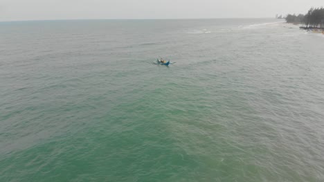 Fly-over-Indonesian-fishing-boat-at-Belitung-Serdang-beach,-aerial