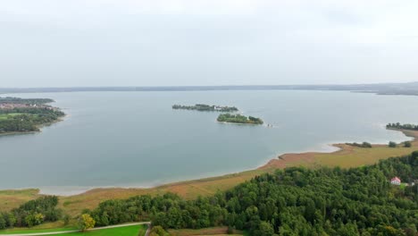 Chiemsee,-Bavaria,-Germany---A-View-of-Freshwater-Lake-Surrounded-by-Lush-Greenery---Aerial-Pullback