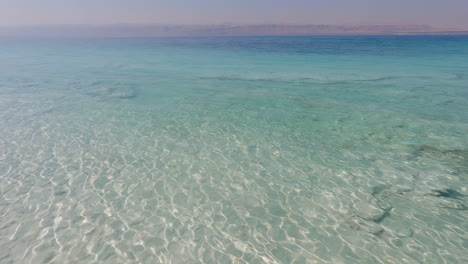 Crystal-clear-turquoise-green-blue-waters-with-light-rays-shimmering,-Dead-Sea