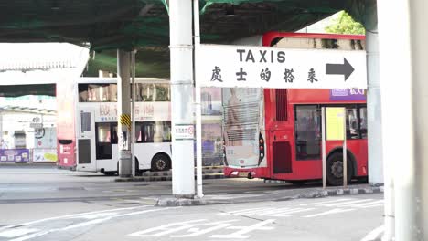Bus-and-taxi-public-transportation-terminal-at-the-iconic-Tsim-Sha-Tsui-pedestrian-area,-Hong-Kong,-China