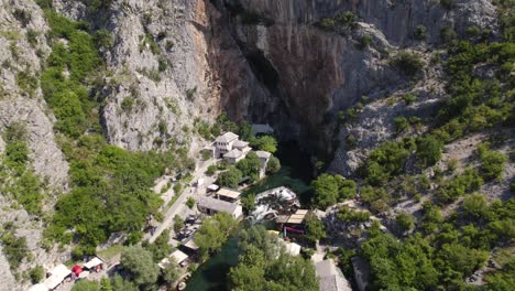 Blagaj-Tekija-Cliffside-Monastery,-Bosnia-Herzegovina-aerial-Wide-view